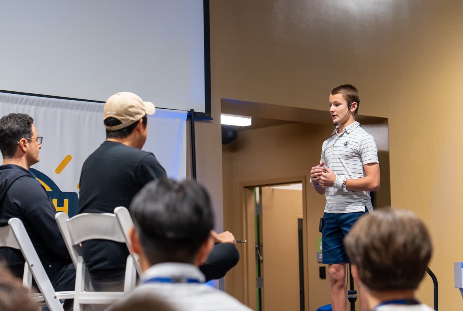 A teen pitching his business idea on stage