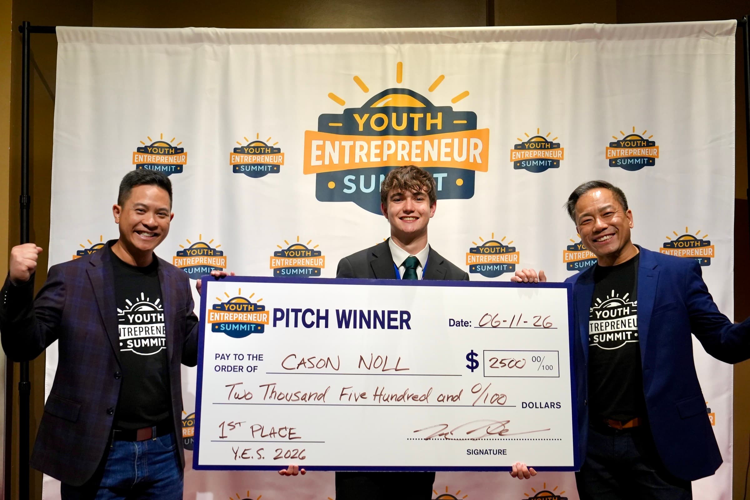 A pitch winner holding his prize check